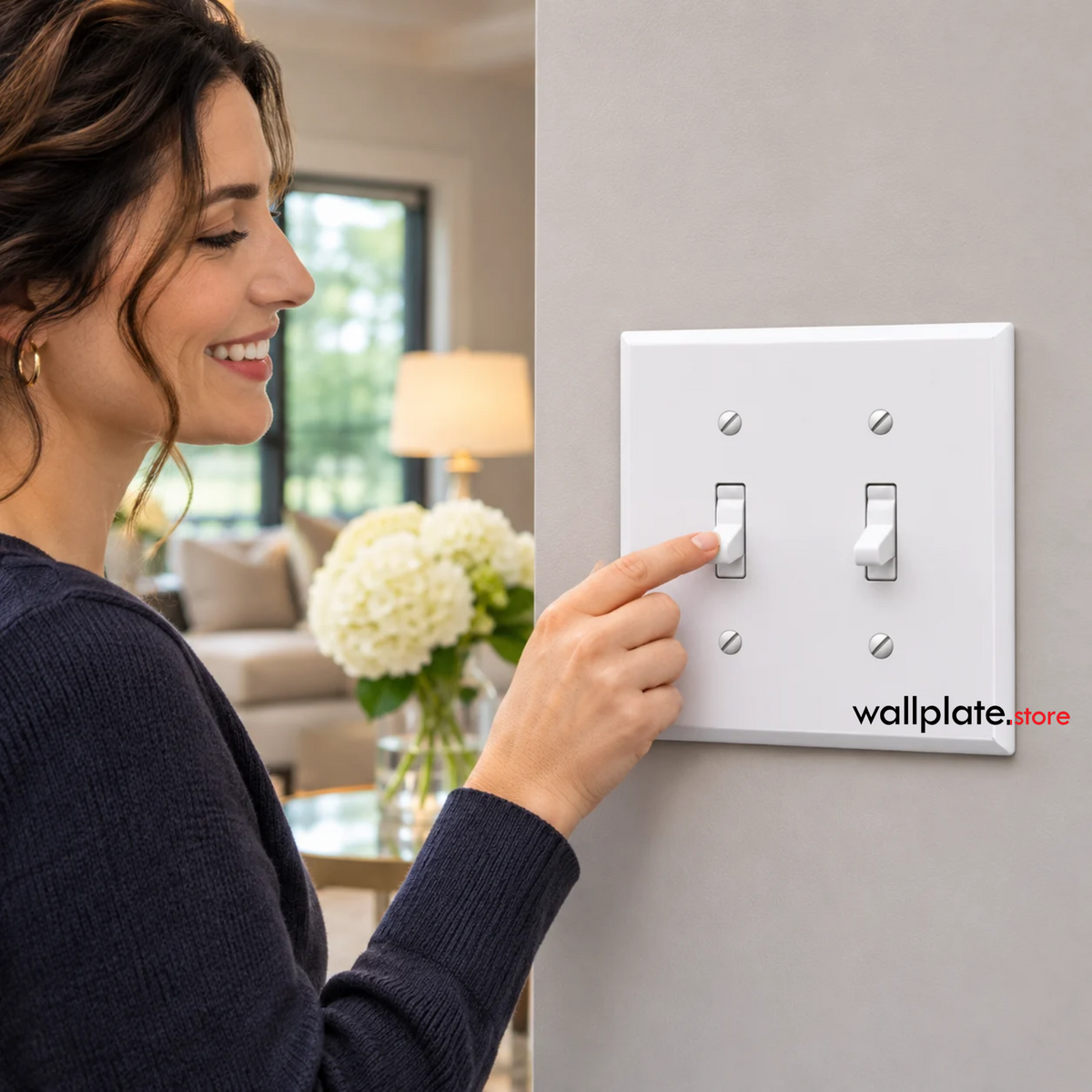 Woman using a white 2-gang jumbo metal wall plate with two toggle switches installed in a modern home interior.